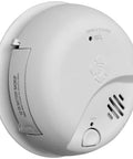 Top Shelf Hardwired Smoke And Carbon Monoxide Detector Combo Built Tough With Rock Solid 10 Year Battery Backup Fully Linked Whole House Fire Safety Alarm Hassle Free 6 Pack Bundle mounted white unit with battery backup access.