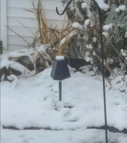 Heavy Duty Solar Hanging Enclosure For LoRa Nodes, secured under snow, black plastic shelter, outdoor winter setup.