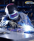 Front view of a welder in protective helmet welding metal; sparks fly and BETOOLL logo is visible.