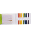 Open pH test paper booklet showing color chart and test strips for measuring acidity or alkalinity.