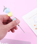 Premium Color Coded Scriber Needle For Sugar Craft And Cake Decorating Icing Pin with colored beads and steel needle in hand.