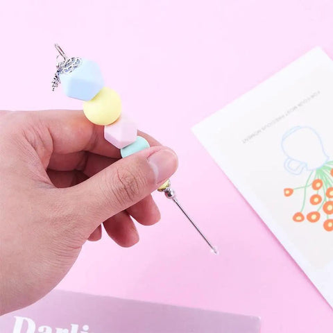 Premium Color Coded Scriber Needle For Sugar Craft And Cake Decorating Icing Pin with colored beads and steel needle in hand.