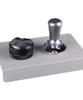 Slick Espresso Tamping Station And Knock Box Fits 58mm Portafilters Like A Glove While Catching Grounds Quickly on gray counter.
