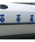 Three blue suction clamps secured to car door, part of a Six Piece Suction Clamp Set For Auto Body Shop And Trim Fastening Non Marking Composite