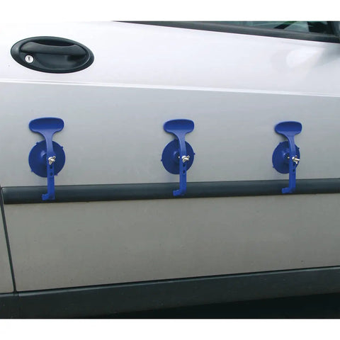 Three blue suction clamps secured to car door, part of a Six Piece Suction Clamp Set For Auto Body Shop And Trim Fastening Non Marking Composite