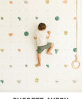 Child climbing on indoor wall with Premium Boho Rock Climbing Holds for Kids Indoor Wall Set in Earth Tones Durable Climbing Wall Props