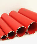 Side view of red diamond wet core drill bit set in six sizes for concrete and masonry.