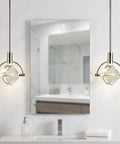 Lamparko Small Pendant Light Fixture with Crystal Cube, Brushed Nickel above a modern bathroom mirror.