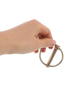 Hand holding Twenty Piece Golden Lynch Pin Set Zinc Coated Carbon Steel For Trailers And Lawn Mowers Beefy Heavy Duty Hitch Pin Kit With Locking Pins Perfect For Trailers Farm Equipment Utility Vehicles And More.