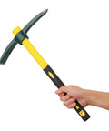 Hand holding Dual Head 15 Inch Garden Pickaxe And Mattock Weeding Hoe with forged steel head and ergonomic rubber handle