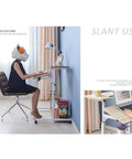Hella Convenient Height Adjustable Overbed Table And Smooth Rolling Mobile Laptop Desk With Rock Solid Frame Sit To Stand Cart For Sofa Or Bed Side Ergonomic Computer Workstation For Home Office in use with user at desk.