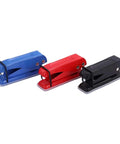 Blue, red, and black staplers arranged in a row on a white background