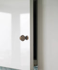 Vintage Pumpkin Drawer Pulls 12 Piece Set Old School Round Cabinet Knobs installed on a white cupboard door.