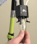 Candelabra Bulb Changer For Chandeliers No Ladder Needed tool in use with bulb, showing pole attachment detail.