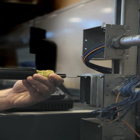 Person using 6 In 1 Tapping Tool From Klein Tools With Cushion Grip For Repairing And Cleaning Threads Auto Re-Threads To Next Size If Stripped on wiring box