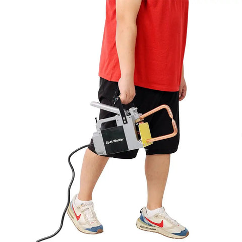 Person holding Portable Spot Welder Gun For Iron Up To One Eighth Inch 110V Handheld Steel Sheet Welder with Copper Tip