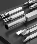 Close-up of the bits from a 24-In-1 Precision Screwdriver Set For Quick Fixes, showcasing various tip shapes on a grey surface.