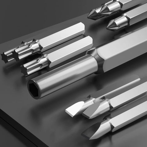 Close-up of the bits from a 24-In-1 Precision Screwdriver Set For Quick Fixes, showcasing various tip shapes on a grey surface.