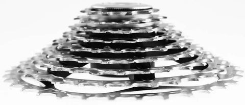 XT 9 Speed Bicycle Cassette 11 To 34T Silver With Lightweight Aluminum Carrier for Mountain Bikes, close-up of gear teeth.