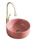 Top Shelf 15.7 Inch Round Pink Ceramic Vessel Bathroom Sink Over Counter Vanity Basin With Super Easy Pop Up Waste Kit Slick High Gloss Glaze Hits Different For Any Modern Home Space featuring a pink gloss sink and gold faucet.