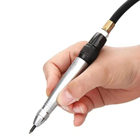 Close-up of hand holding Real Deal Air Scribe Engraving Pen With Pneumatic Pencil Design for etching.