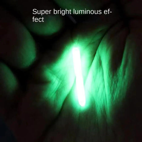 100 Pack Ultra Pro Grade Slim 3Mm Fluorescent Glow Light Sticks glowing green in hand for night fishing visibility.