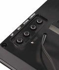 Back view of black digital kitchen clock with four round buttons labeled UP, SET, DOWN, COMPASS and a power cord