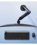 Rock Solid Single Monitor Desk Mount With Smooth Floating Arm Fits Up To 32 Inch Screens Holds 4.4 To 19.8 Lbs above a keyboard and mouse.