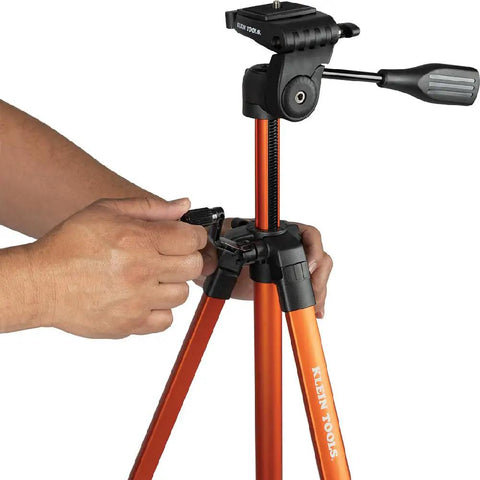 Person adjusting lightweight aluminum tripod with mount for laser levels, showing its flexible and stable features for uneven terrain.