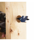 Close-up of Bosch DSB1013 Daredevil spade bit, 1 in. dia x 6 in., blue-coated, drilling into wood.