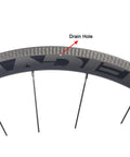 Close-up of Dope 700C Carbon Clincher Wheelset with 38mm Aero Rim Tubeless Ready detailing drain hole and spoke attachment