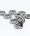 Top Shelf 10 Pack MF93 Flanged Bearings Featuring ABEC 3 Grade Precision, chrome steel mini ball bearings in a pile.