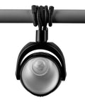 Portable LED Motion Sensor Light With 148 Lumens, 13 Ft Detectable Range, Flexible Tripod Base, hanging from a rod.
