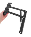 Side view of black metal heavy-duty lift-up hinge with spring and mounting plates for drop-leaf table