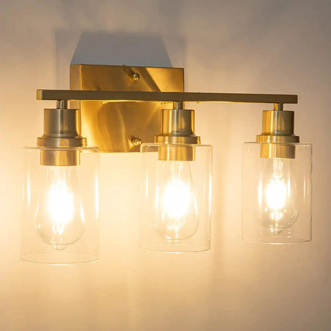 Three-Light Vanity Light With Clear Glass Shades In Brushed Brass Finish Wall Sconce For Bathroom Hallway And Living Areas Modern Farmhouse Style Vibe Easy Install Durable Metal Construction