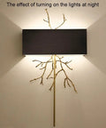Modern Copper Wall Sconce Featuring Brushed Stainless Steel Shade For Bedrooms Hallways And Living Rooms illuminating wall with unique design.