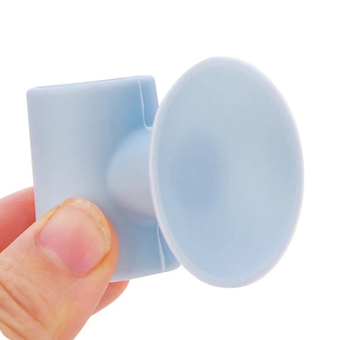 Person holding Silicone Suction Cup Door Stopper Wall Protector With Noise Reduction Pad for glass tile metal surfaces close-up