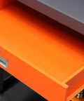 Close-up of the orange storage drawer in Heavy Duty Steel Workbench With Smart Storage Cabinet And Wall Pegboard For Garage Tools.