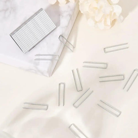 Heavy Duty 80 Piece Plantation Shutter Louver Repair Kit, Brushed Nickel Window Blind Bracket Set showing metal clips on a marble surface.
