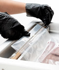 Hands in black gloves sealing a bag with a Pro Grade Chamber Vacuum Sealer Packs A Solid Punch With Sturdy 16 Inch Seal Bar And Whisper Quiet Motor.