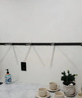 Heavy Duty Floating Shelf Brackets Fifty Eight Inches Long Invisible Mantel Supports For Thick Lumber Boards Matte Black Alloy Wall Mount Holders displayed with cups.