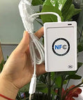Hand holding ACR122u A9 Dope Reader Writer For Rewritable UID Changeable Cards with USB cable, NFC logo visible.