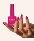 Hand holding CANNI 9ml pink gel nail polish, showcasing vibrant color application, related to Hema Free Gel Nail Polish Set 9ml Six Pack