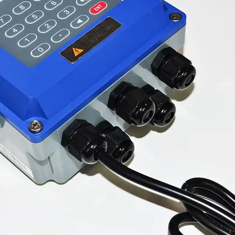 Close-up view of Digital Ultrasonic Flow Meter For Liquids TUF-2000B connections, showing bi-directional setup, IP67 casing.