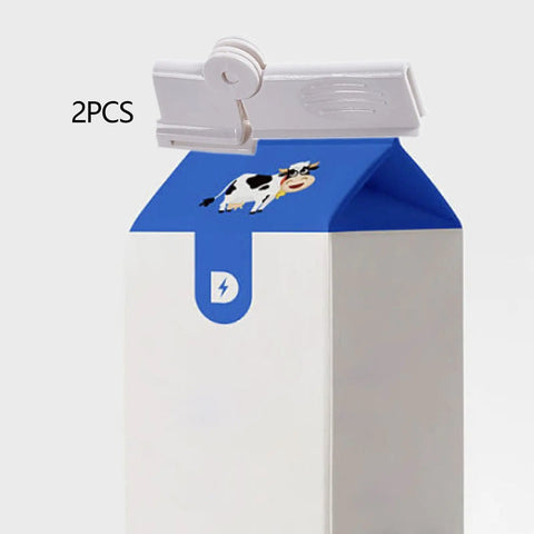 Jisader Two Pack Milk Carton Sealing Clips With Rotating Design For Boxed Drinks And Food Bags on a milk carton.