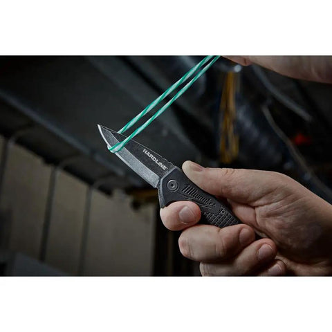 Dead Simple Pocket Knife With Smooth Slide Action And Heavy Duty Plastic Guard compact black hand tool cutting through rubber band.
