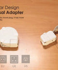 Power Station Traveler Bundle With Universal Travel Adapter on wooden table, featuring modular design and multiple plug types.