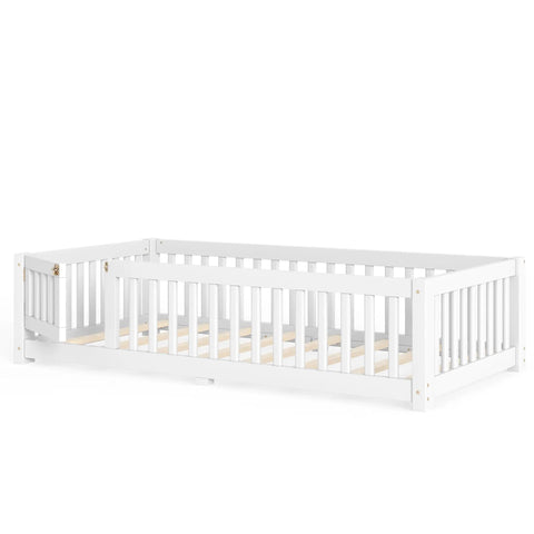 Totally Built Tough Twin Floor Bed With Montessori Design And Complete Safety Guardrails Plus Easy Access Door For Kids, Solid Wood Low Profile Slatted Frame In Fresh White viewed from the side.