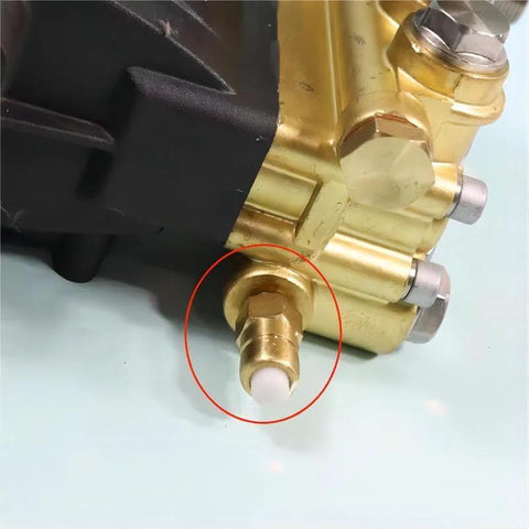 Brass thermal release relief valve for pressure washer; close-up view with white actuator tip.