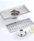 Premium Stainless Steel Rectangular Floor Drain For Bathroom With Massive Flow Deodorant Hair Catcher, showing drain and hair trap.